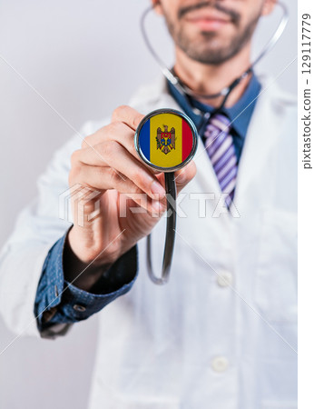 Moldova health and medical insurance concept. Moldova healthcare system, doctor holding stethoscope Moldova health and medical insurance concept. Moldova healthcare system, doctor holding stethoscope 129117779