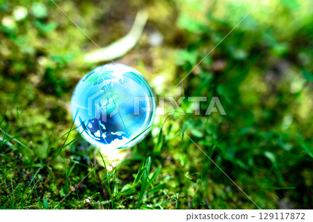 Beautiful backlit globe crystal. Ecological image. Blue morning color, bright. 129117872