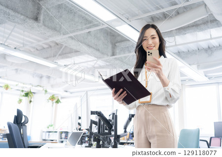 Young female engineer in office casual wear Young female engineer in office casual wear 129118077