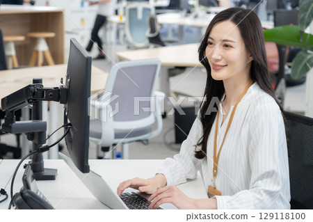 Young female engineer in office casual wear Young female engineer in office casual wear 129118100