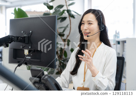 A young female operator in office casual wear A young female operator in office casual wear 129118113