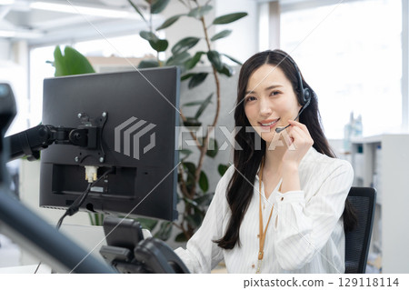 A young female operator in office casual wear A young female operator in office casual wear 129118114