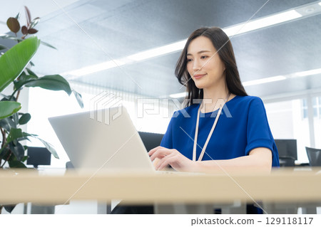 Young female engineer in office casual wear 129118117