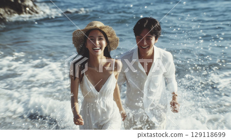 Summer beach resort: two men and women walking on the sand 129118699