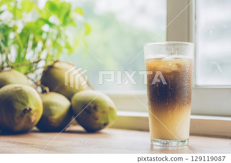 Vietnamese coconut coffee in a tall glass on window sill 129119087