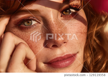 close up face of red haired model girl with perfected no-makeup skin and freckles in natural daylight 129119358