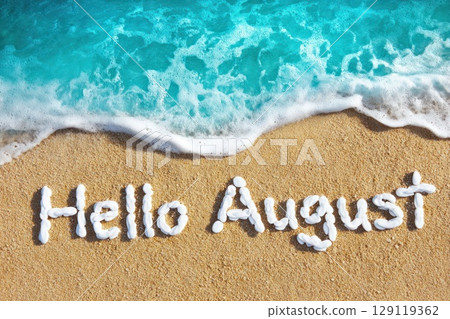turquoise sea water on sand beach with text made with white pebbles 'Hello August' 129119362