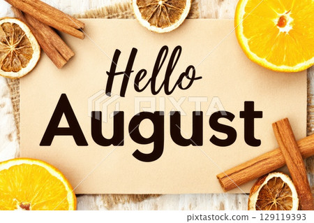 Hello August banner with orange slices and cinnamon sticks on natural background Hello August banner with orange slices and cinnamon sticks on natural background 129119393