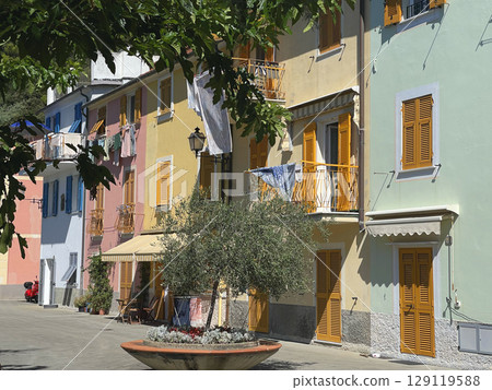 Old street in Italian countryside near sea. Traditional building. Sun day. Entrance, window to house. Nature and sky. 129119588