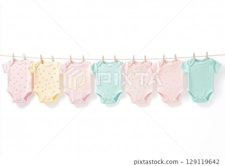 Clothing rack with children's clothes hung isolated on white background. Set of children bodysuits pastel colored. Kid's outfit on hangers. Kids wardrobe. Baby garment. Dressing. New baby apparel 129119642