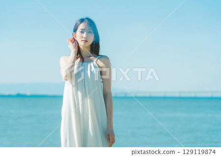 young woman against the background of the sea 129119874