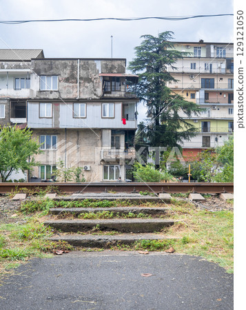 Pedestrian crossing over the railway on the outskirts of the city. Train danger. Dangerous place. Pedestrian crossing over the railway on the outskirts of the city. Train danger. Dangerous place. 129121050