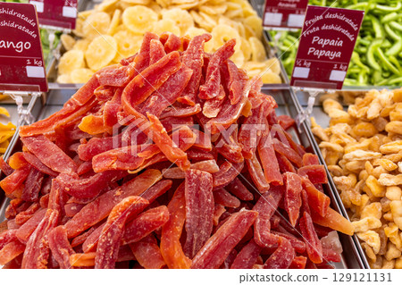 Red dried fruits of papaya and other offered at a market stall 129121131
