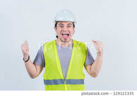 Happy engineer celebrating on isolated background. Excited engineer gesturing celebration isolated Happy engineer celebrating on isolated background. Excited engineer gesturing celebration isolated 129121335