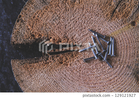 Fasteners for wood. Self-tapping screws on a wooden table. Fasteners for wood. Self-tapping screws on a wooden table. 129121927