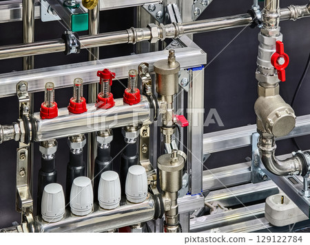 Piping and valve system in a modern industrial facility showcasing advanced plumbing technology 129122784