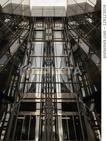 the contemporary architecture featuring glass elevators within One New Change notable for its distinctive modern design. 129123034
