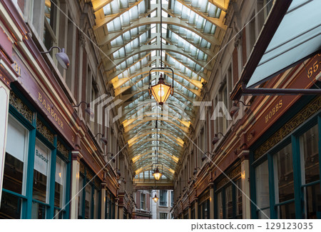 The spectacular victorian architecture of Leadenhall Market is housed beneath, is a combination of ornate wrought-iron, glass roof. 129123035