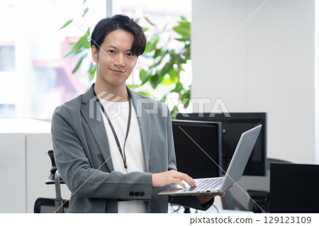 A young male engineer in office casual wear 129123109