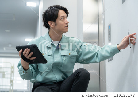 Young male engineer doing office maintenance Young male engineer doing office maintenance 129123178