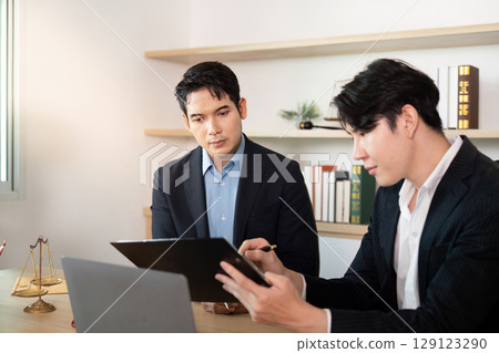 Business Meeting. Two lawyers discussing legal documents in office. Business Meeting. Two lawyers discussing legal documents in office. 129123290