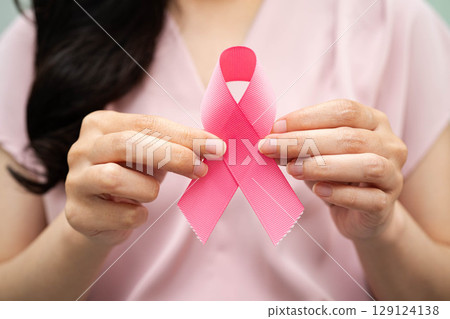 Asian woman with pink ribbon, World Breast Cancer Day at October. Asian woman with pink ribbon, World Breast Cancer Day at October. 129124138
