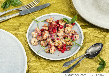 Grilled shrimps or prawns served with berry. Grilled shrimps or prawns served with berry. 129124620