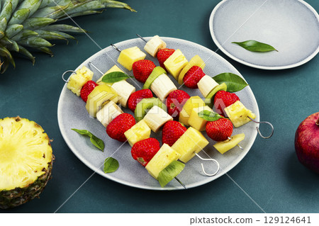 Fruits on skewers, dessert. 129124641