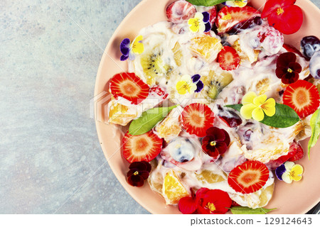 Summer flowers fruit salad. 129124643