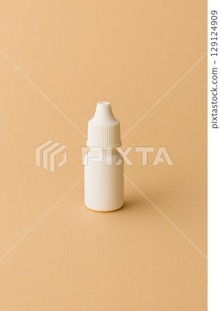 A white eye drop bottle placed on a soft background | Home medical care, nursing care, and clean medical image 129124909