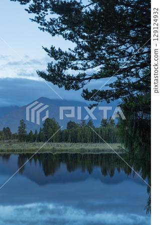 Mount Cook in clouds as seen from Lake Matheson on the West Coast of New Zealand Mount Cook in clouds as seen from Lake Matheson on the West Coast of New Zealand 129124932