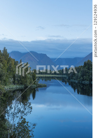 Mount Cook in clouds as seen from Lake Matheson on the West Coast of New Zealand Mount Cook in clouds as seen from Lake Matheson on the West Coast of New Zealand 129124936