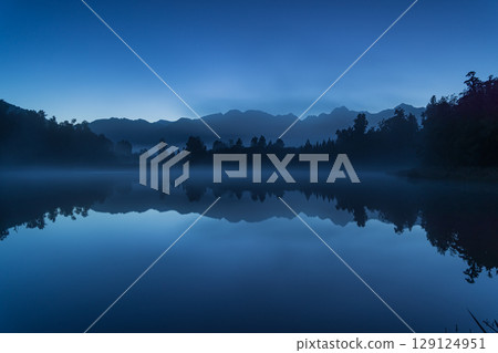 Mount Cook seen from Lake Matheson in the early morning mist, West Coast, New Zealand Mount Cook seen from Lake Matheson in the early morning mist, West Coast, New Zealand 129124951