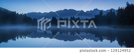 Mount Cook seen from misty Lake Matheson on New Zealand's West Coast in the early morning Mount Cook seen from misty Lake Matheson on New Zealand's West Coast in the early morning 129124952