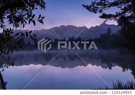 Mount Cook and the sunrise seen from Lake Matheson in the early morning mist, New Zealand Mount Cook and the sunrise seen from Lake Matheson in the early morning mist, New Zealand 129124955
