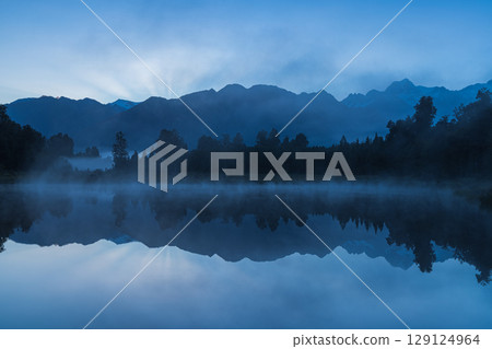 Mount Cook seen from misty Lake Matheson on New Zealand's West Coast in the early morning Mount Cook seen from misty Lake Matheson on New Zealand's West Coast in the early morning 129124964