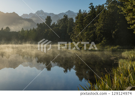 Mount Cook seen from misty Lake Matheson on New Zealand's West Coast in the early morning Mount Cook seen from misty Lake Matheson on New Zealand's West Coast in the early morning 129124974