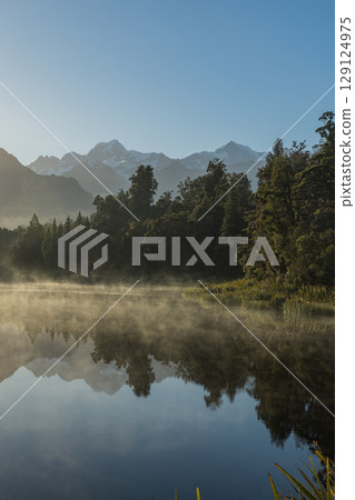 Mount Cook seen from misty Lake Matheson on New Zealand's West Coast in the early morning Mount Cook seen from misty Lake Matheson on New Zealand's West Coast in the early morning 129124975