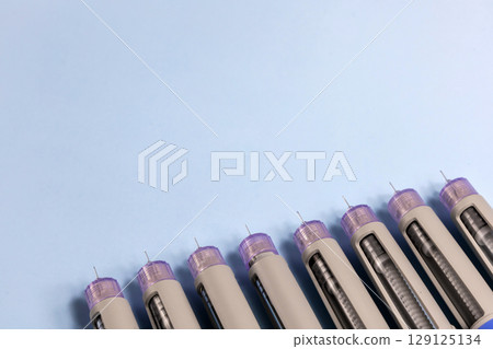 Syringes with needles in a row 129125134