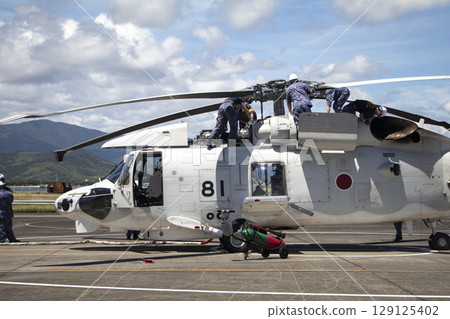 A crew member conducting a post-flight inspection A crew member conducting a post-flight inspection 129125402