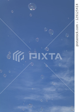 Bubbles floating in the blue sky Bubbles floating in the blue sky 129125414