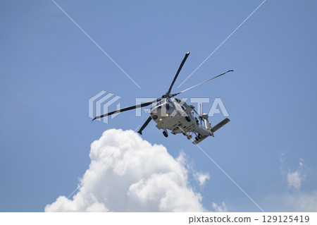 Self-Defense Force helicopter flying in the blue sky 129125419