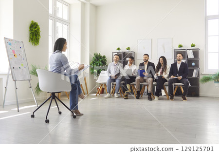 Business training of corporate staff, board presentation for sitting employees team in office 129125701