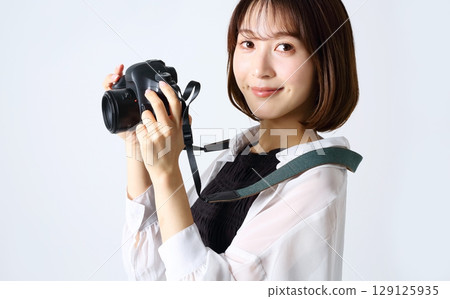 SLR camera and woman image SLR camera and woman image 129125935