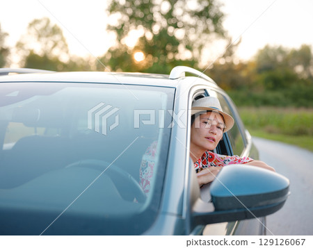 Traveler woman drives car through scenic countryside of Croatia 129126067