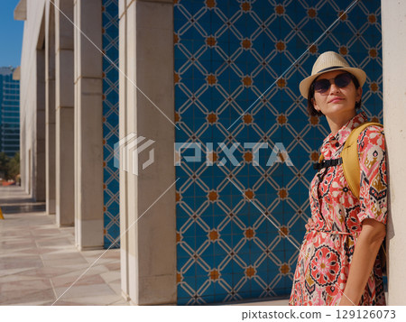 Young female tourist exploring iconic landmarks of the United Arab Emirates. 129126073