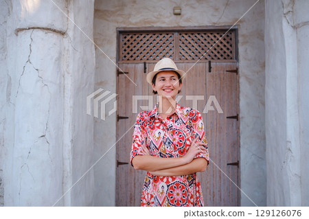 Young female tourist exploring iconic landmarks of the United Arab Emirates. 129126076