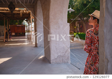 Young female tourist exploring iconic landmarks of the United Arab Emirates. 129126077