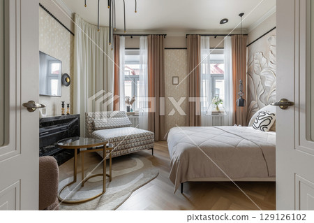 Stylish Bedroom Interior with Soft Lighting and Decor Stylish Bedroom Interior with Soft Lighting and Decor 129126102