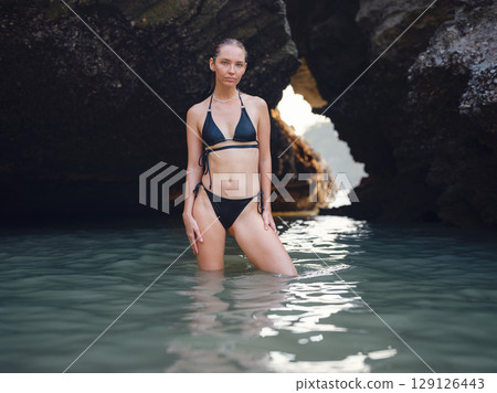 Young woman enjoying serene evening at sea in Krabi, Thailand 129126443